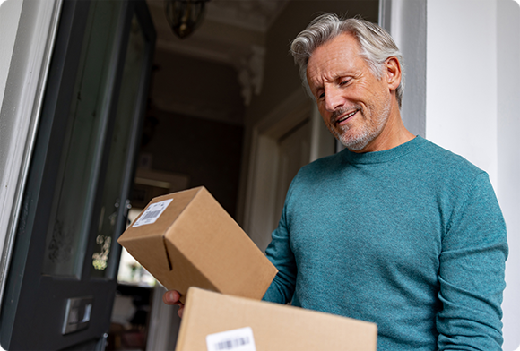 Man receives packages from his front door