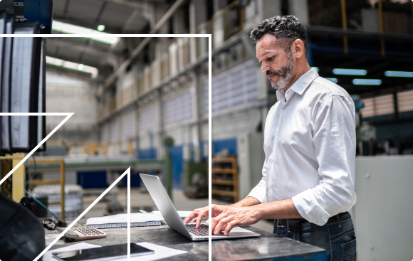 Man searches computer in warehouse setting