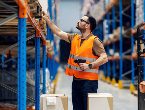 Warehouse worker looks for inventory