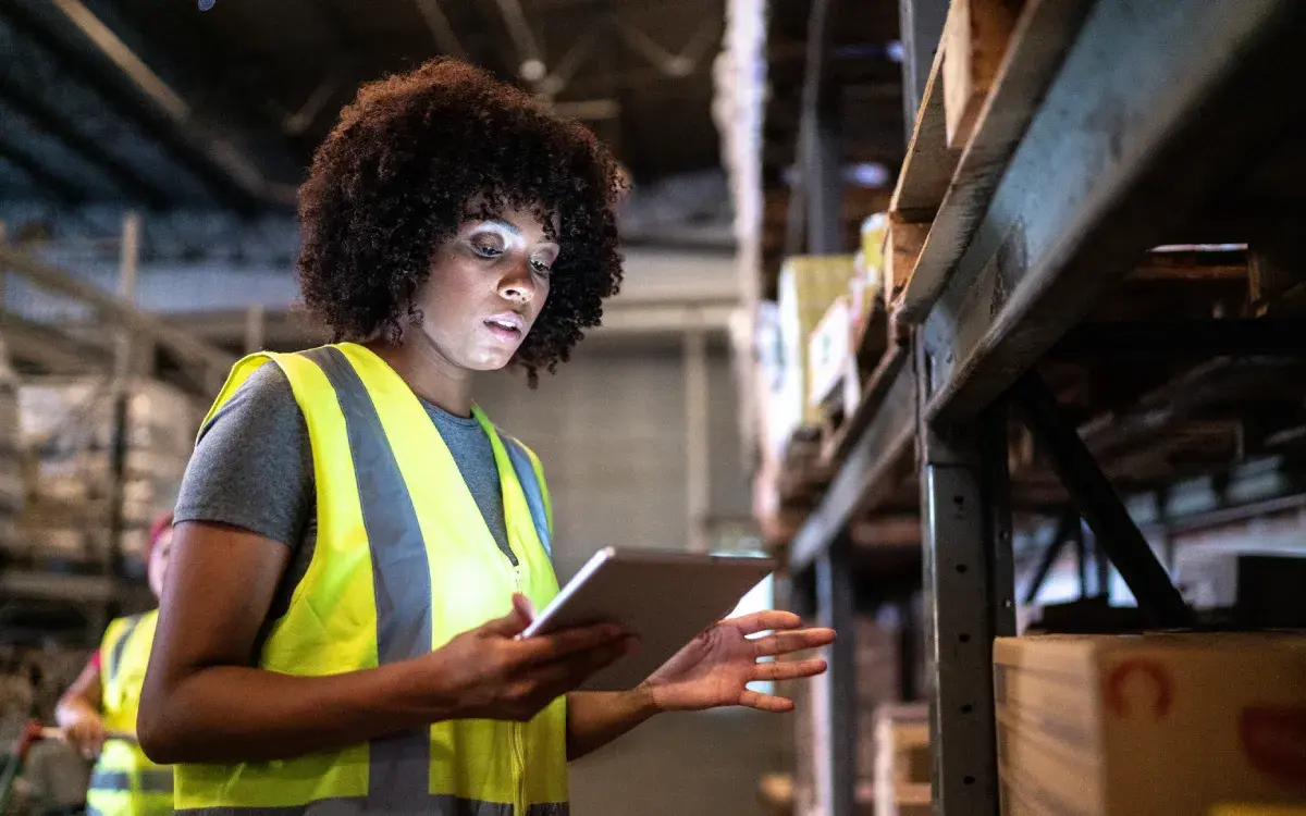 Warehouse employee using InfoPlus warehouse management software.